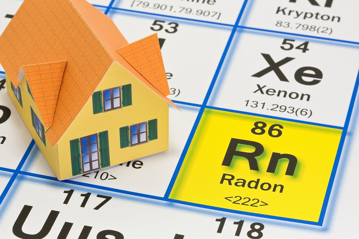 The danger of natural radon gas in our homes - concept with the Mendeleev periodic table of the elements and residential home model